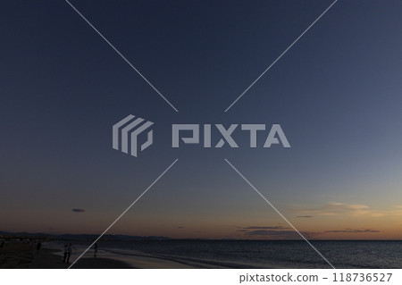 Sunrise. Dawn. Dawn in the sea. Sunrise in the sea. The first rays of sunlight rising through the sea water leaving a colorful, orange sky. Sun rays reflected in the waves of the sea. 118736527