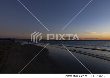 Sunrise. Dawn. Dawn in the sea. Sunrise in the sea. The first rays of sunlight rising through the sea water leaving a colorful, orange sky. Sun rays reflected in the waves of the sea. Sunrise. Dawn. Dawn in the sea. Sunrise in the sea. The first rays of sunlight rising through the sea water leaving a colorful, orange sky. Sun rays reflected in the waves of the sea. 118736528