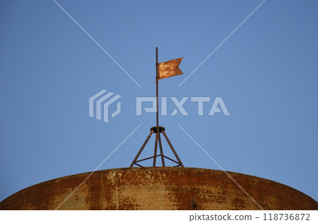 a small red iron flag on the roof of the tank 118736872