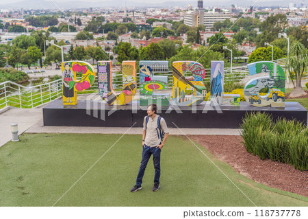 Male tourist in front of the panoramic view of Puebla city, Mexico. Travel, cultural exploration, and scenic landscape concept 118737778
