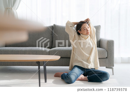 A woman relaxing in the room A woman relaxing in the room 118739378