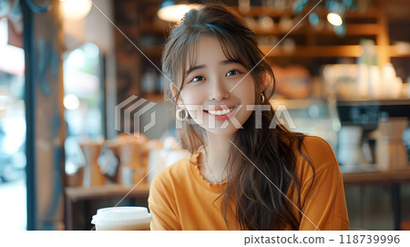 Young woman drinking iced cafe au lait in a bright cafe 118739996