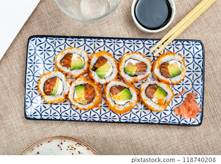 Plate is filled with California rolls with masago. Plate is filled with California rolls with masago. 118740208