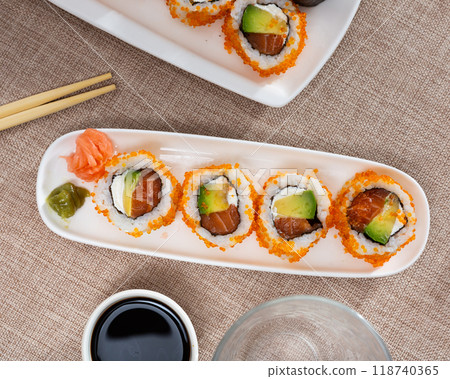 Japanese dish california roll masago with salmon, avocado, cheese and caviar closeup Japanese dish california roll masago with salmon, avocado, cheese and caviar closeup 118740365