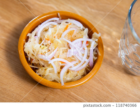 Homemade pickled cabbage with onion on bowl, natural probiotic. Popular Russian dish 118740366