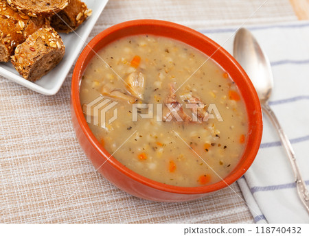 Pearl barley soup with pork and mushrooms 118740432