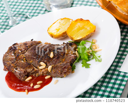Prepared beef steak with tomatoe ketchup and pine nuts 118740523