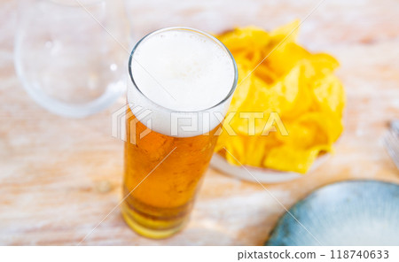 Glass of beer with chips for snack 118740633