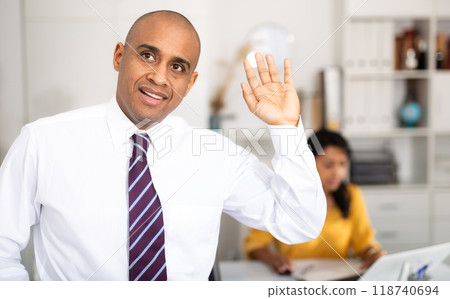 Businessman greets someone in the office Businessman greets someone in the office 118740694