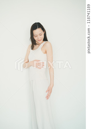 Woman touching her left side Woman touching her left side 118741189
