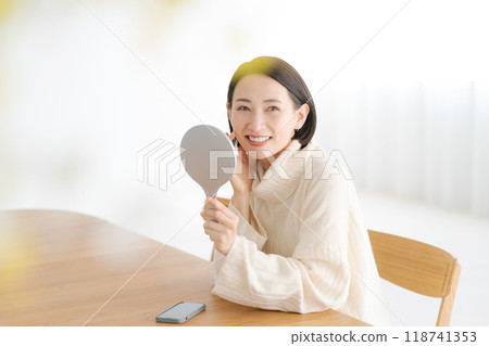 A woman in her 40s smiling in the mirror A woman in her 40s smiling in the mirror 118741353