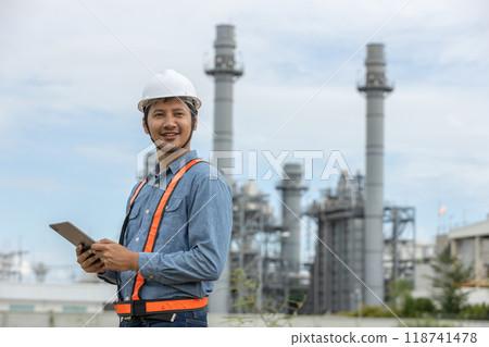 Engineer with tablet working factory producing electricity oil energy. Engineer with tablet working factory producing electricity oil energy. 118741478