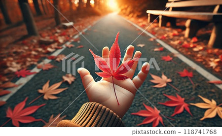 A maple leaf in the palm of a small hand 118741768