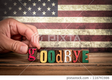 GOODBYE. Colorful letters of the alphabet on a wooden texture table 118741986