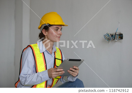 Construction civil engineer woman using tablet checking quality Manage electrical system office 118742912