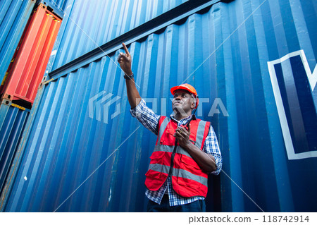 Man american african with talkie walkie at worker industry dock or container yard. 118742914