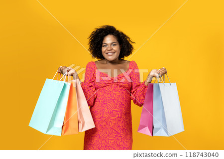 Young girl with shopping bags in her hands Young girl with shopping bags in her hands 118743040