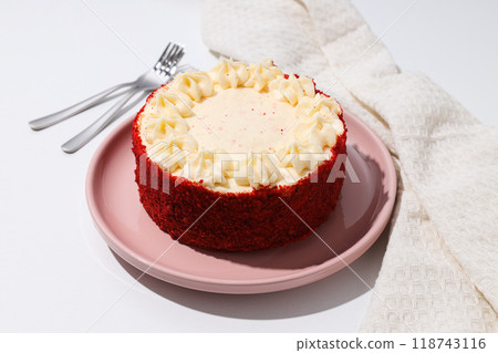 Red velvet cake on pink plate and towel on white background 118743116