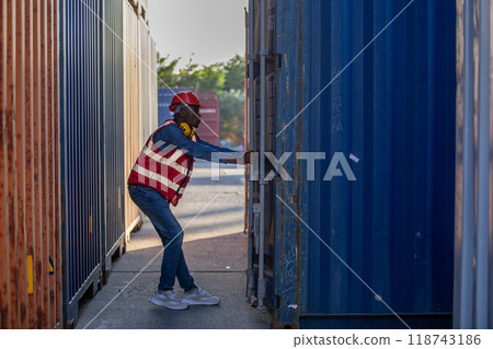 Male african american foreman opening door of container Male african american foreman opening door of container 118743186