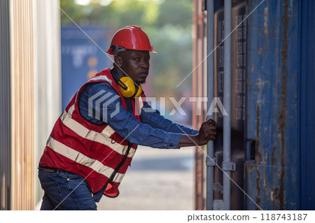 Male african american foreman opening door of container. Male african american foreman opening door of container. 118743187