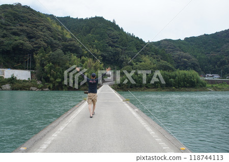 People crossing the Niyodo River submerged bridge 118744113