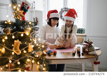 Mother and daughter baking cookies together at Christmas Mother and daughter baking cookies together at Christmas 118744274