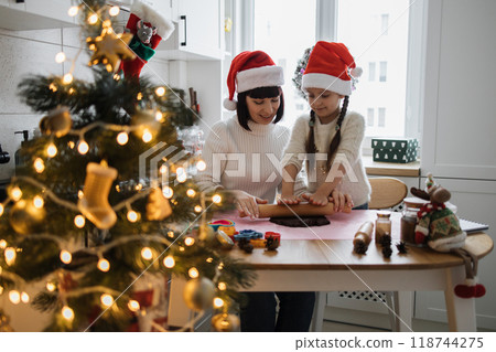Mother and daughter baking cookies during Christmas holiday Mother and daughter baking cookies during Christmas holiday 118744275