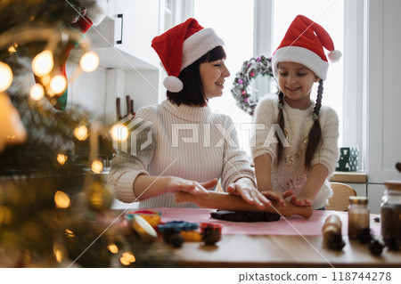 Mother and daughter baking together during Christmas holiday 118744278