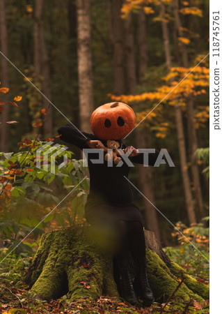 Surreal Pumpkin Head in Autumn Forest 118745761
