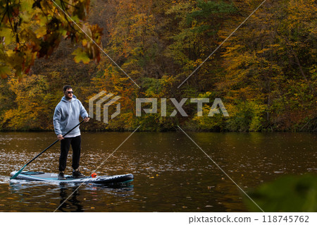 Paddleboarding in Autumn Serenity Paddleboarding in Autumn Serenity 118745762