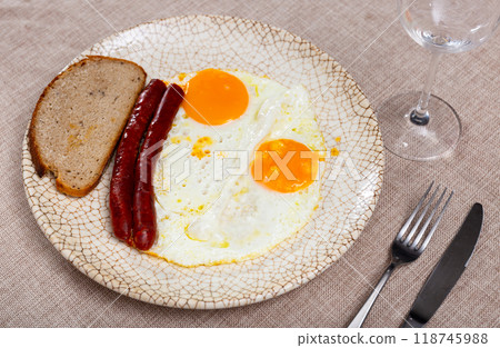 Grilled chistorra sausages with fried eggs for breakfast Grilled chistorra sausages with fried eggs for breakfast 118745988