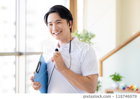 Male caregiver working with a wireless microphone 118746079