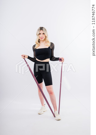 Photo of woman workout with resistance band. Strength and motivation. Photo of woman workout with resistance band. Strength and motivation. 118746774
