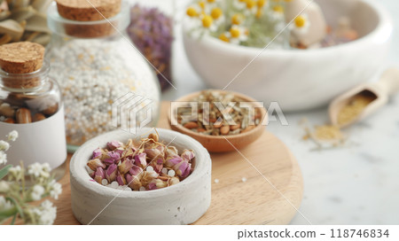 Close-up of natural bath products, herbs, and flowers in a spa setting. Focus on organic ingredients for relaxation and self-care rituals. 118746834