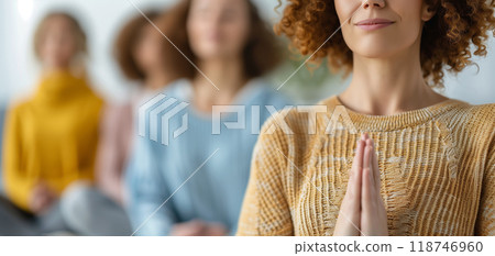 Group of women meditating indoors, practicing mindfulness and relaxation with closed eyes, focusing on inner peace and well-being. 118746960