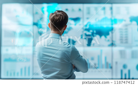 Back view of a professional analyzing global data and statistics on multiple screens in a modern office environment. 118747412