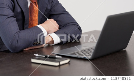 A businessman worried in front of a computer 118748551