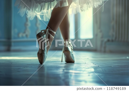 A ballet dancer showcases her skills on pointe in a bright studio, emphasizing grace and artistry in motion 118749189