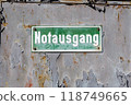 Green plate with a white inscription - emergency exit 118749665