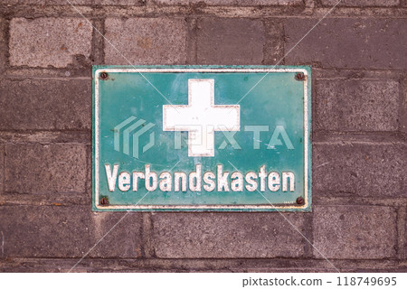 Green plate with a white cross and inscription - first aid kit Green plate with a white cross and inscription - first aid kit 118749695