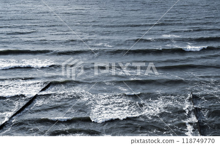 Waves are breaking at old wooden breakwaters, Baltic Sea coast 118749770