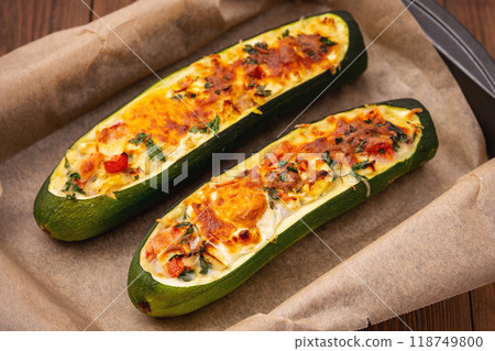 Zucchini stuffed with feta cheese, egg, parsley and cherry tomatoes 118749800