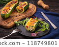 Zucchini stuffed with feta cheese, egg, parsley and cherry tomatoes 118749801