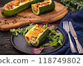 Zucchini stuffed with feta cheese, egg, parsley and cherry tomatoes 118749802