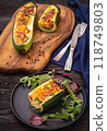 Zucchini stuffed with feta cheese, egg, parsley and cherry tomatoes 118749803