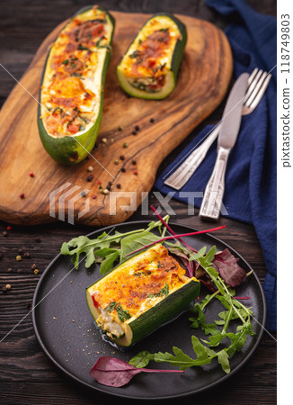 Zucchini stuffed with feta cheese, egg, parsley and cherry tomatoes Zucchini stuffed with feta cheese, egg, parsley and cherry tomatoes 118749803