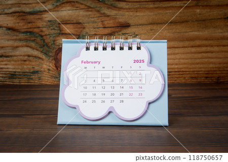 FEBRUARY 2025. cardboard desk calendar on a wooden texture background FEBRUARY 2025. cardboard desk calendar on a wooden texture background 118750657