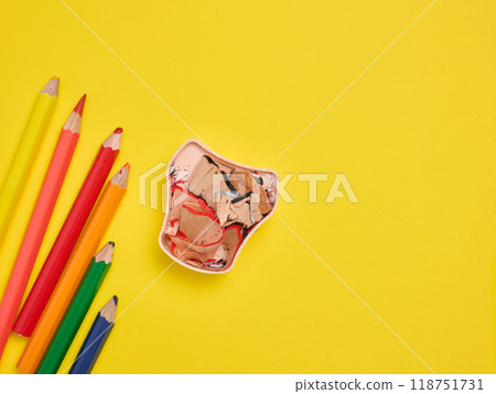 Multicolored wooden pencils and sharpener on yellow background, top view Multicolored wooden pencils and sharpener on yellow background, top view 118751731