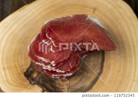 sliced ham with bacon on a board 118752345