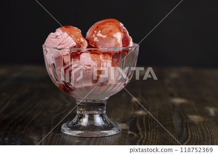 red strawberry-flavored ice cream in a glass bowl red strawberry-flavored ice cream in a glass bowl 118752369
